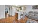 Bright kitchen with white cabinets, white appliances, breakfast bar with seating, and hardwood floors at 510 Fairwood Lakes Dr. # 923G, Myrtle Beach, SC 29588