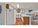 Bright kitchen with wooden cabinets, white appliances, and a breakfast bar overlooking the living area at 510 Fairwood Lakes Dr. # 923G, Myrtle Beach, SC 29588