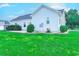 Spacious backyard with lush green lawn and the home's white exterior siding at 548 Fox Chase Dr., Conway, SC 29527