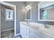 Bright bathroom with gray walls, double sinks, white cabinets, and a view into the toilet room at 548 Fox Chase Dr., Conway, SC 29527
