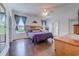 Bright bedroom with wood-look flooring, a ceiling fan, and windows with natural light at 548 Fox Chase Dr., Conway, SC 29527