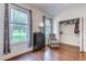 Bedroom with hardwood floors, windows with natural light, a dark dresser, comfy chair, and walk-in closet at 548 Fox Chase Dr., Conway, SC 29527