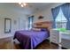 Bright bedroom with wood-look flooring, a ceiling fan, windows with natural light, and a dresser at 548 Fox Chase Dr., Conway, SC 29527