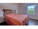 Cozy bedroom with a wood accent headboard and bright light from the exterior window at 548 Fox Chase Dr., Conway, SC 29527