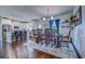 Dining room featuring a long wooden table, chairs, elegant chandelier, and adjacent kitchen area at 548 Fox Chase Dr., Conway, SC 29527