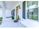 Inviting front porch with white columns, planters, and wood door at 548 Fox Chase Dr., Conway, SC 29527