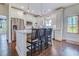 Well-lit kitchen with white cabinets, stainless steel appliances, barstool seating and hardwood floors at 548 Fox Chase Dr., Conway, SC 29527