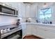 Close-up of a kitchen with white cabinets, stainless steel appliances, and ample counter space at 548 Fox Chase Dr., Conway, SC 29527