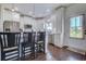 Kitchen featuring white cabinets, stainless steel appliances, bar stool seating, and a view to the back door at 548 Fox Chase Dr., Conway, SC 29527