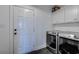 A convenient laundry room with modern machines, white cabinets, and dark stone floor at 548 Fox Chase Dr., Conway, SC 29527