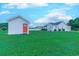 A beautiful yard featuring a shed, with lush green grass, complemented by the home in the background at 548 Fox Chase Dr., Conway, SC 29527