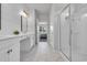 Contemporary bathroom boasting dual vanities, a glass-enclosed shower, and marble flooring at 553 Pier Ct., Longs, SC 29568