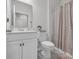 Sparkling clean bathroom with lovely neutral colors and fluffy rug at 553 Pier Ct., Longs, SC 29568