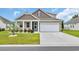 Charming home features a two-car garage, manicured lawn, and beautiful curb appeal at 553 Pier Ct., Longs, SC 29568