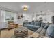 Comfortable living room featuring a blue sectional sofa and plenty of natural light at 553 Pier Ct., Longs, SC 29568