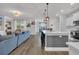Spacious living room opens to kitchen with white cabinets and barstool seating at 553 Pier Ct., Longs, SC 29568