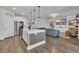 Open-concept living area with a kitchen island, stainless steel appliances, and living room view at 553 Pier Ct., Longs, SC 29568