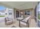 Comfortable screened porch area with neutral furnishings and outdoor TV is perfect for relaxing at 553 Pier Ct., Longs, SC 29568