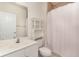 Bright bathroom featuring white fixtures, vanity, toilet, shower with curtain, and built-in cabinet at 5750 Oyster Catcher Dr. # 531, North Myrtle Beach, SC 29582