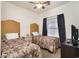 Comfortable bedroom with two beds, neutral decor, and a window offering natural light at 5750 Oyster Catcher Dr. # 531, North Myrtle Beach, SC 29582