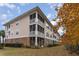 Multi-story building with screened porches and well-maintained landscaping, showing a residential appeal at 5750 Oyster Catcher Dr. # 531, North Myrtle Beach, SC 29582