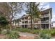 Condo building with manicured landscaping, featuring screened balconies perfect for outdoor enjoyment at 5750 Oyster Catcher Dr. # 531, North Myrtle Beach, SC 29582