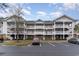 Charming condo building with multiple stories, covered decks, and well-maintained landscaping, near parking at 5750 Oyster Catcher Dr. # 531, North Myrtle Beach, SC 29582