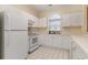 Spacious kitchen featuring all white appliances, cabinets, and a bright arched window at 5750 Oyster Catcher Dr. # 531, North Myrtle Beach, SC 29582