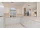 Bright kitchen featuring white cabinets, appliances, and countertops, with a pass-through to the living room at 5750 Oyster Catcher Dr. # 531, North Myrtle Beach, SC 29582