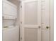 Convenient laundry area featuring a stacked washer and dryer unit and a louvered door at 5750 Oyster Catcher Dr. # 531, North Myrtle Beach, SC 29582