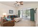 Bright living room with vaulted ceiling, ceiling fan, comfortable furniture, and sliding glass doors to the balcony at 5750 Oyster Catcher Dr. # 531, North Myrtle Beach, SC 29582