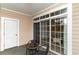 Cozy outdoor patio with sliding glass doors and seating area for relaxing and enjoying the view at 5750 Oyster Catcher Dr. # 531, North Myrtle Beach, SC 29582