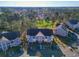 Aerial view of a community surrounded by lush greenery, featuring multiple buildings and ample parking at 5822 Longwood Dr. # 104, Murrells Inlet, SC 29576