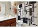 Bathroom with dark wood vanity, single sink, and black and white geometric shower curtain at 5822 Longwood Dr. # 104, Murrells Inlet, SC 29576