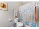 Standard bathroom featuring a toilet, shell artwork, and shower curtain with sea life pattern at 5822 Longwood Dr. # 104, Murrells Inlet, SC 29576