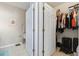 Bathroom adjacent to closet with tile floors and open white doors at 5822 Longwood Dr. # 104, Murrells Inlet, SC 29576