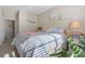Bright bedroom with queen bed, white furniture, and decoratively accented walls at 5822 Longwood Dr. # 104, Murrells Inlet, SC 29576