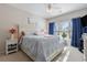 Bright bedroom with queen bed, white furniture, ceiling fan, and natural light from window at 5822 Longwood Dr. # 104, Murrells Inlet, SC 29576