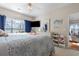 Spacious bedroom features a large window, ceiling fan, dresser, and mounted flat screen TV at 5822 Longwood Dr. # 104, Murrells Inlet, SC 29576