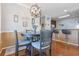 Cozy dining area featuring hardwood floors, a stylish table, four chairs, and an open view to the kitchen bar at 5822 Longwood Dr. # 104, Murrells Inlet, SC 29576