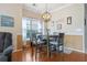 Charming dining area with hardwood floors, table with four chairs, illuminated by a stylish orb chandelier at 5822 Longwood Dr. # 104, Murrells Inlet, SC 29576