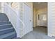 Exterior of a property featuring gray stairs leading to a white door and sidelight, complemented by beige siding at 5822 Longwood Dr. # 104, Murrells Inlet, SC 29576