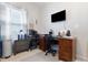 Functional home office with wood desk, neutral walls and natural light at 5822 Longwood Dr. # 104, Murrells Inlet, SC 29576