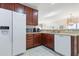 Well-lit kitchen featuring stainless steel appliances, and dark wood cabinets for ample storage at 5822 Longwood Dr. # 104, Murrells Inlet, SC 29576