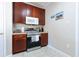 Kitchen area with stainless steel oven, wood cabinets and tile floor at 5822 Longwood Dr. # 104, Murrells Inlet, SC 29576