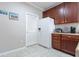 Kitchen features white refrigerator, wood cabinets, and tile flooring at 5822 Longwood Dr. # 104, Murrells Inlet, SC 29576