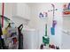 Functional laundry room with washer, dryer, storage shelves, and essential cleaning supplies at 5822 Longwood Dr. # 104, Murrells Inlet, SC 29576