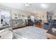 Inviting living area featuring hardwood floors, comfortable reclining chairs, and adjacent dining area with modern decor at 5822 Longwood Dr. # 104, Murrells Inlet, SC 29576