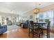 Open-concept living area with hardwood floors, comfortable reclining chairs, and dining table under a unique chandelier at 5822 Longwood Dr. # 104, Murrells Inlet, SC 29576