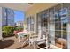 Screened-in patio with table, chairs, and view of well maintained lawn and landscaping at 5822 Longwood Dr. # 104, Murrells Inlet, SC 29576